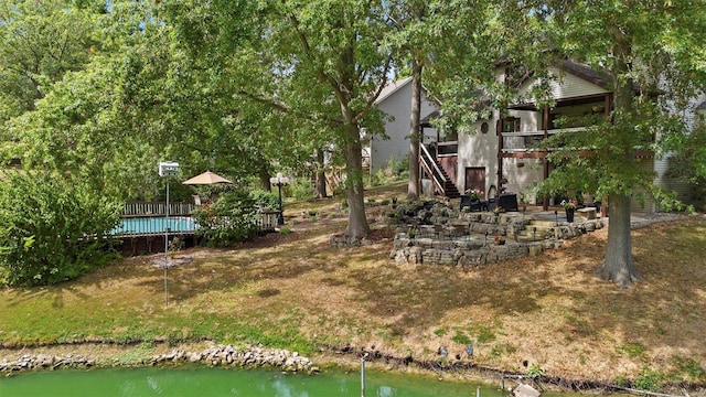 view of yard with a deck with water view