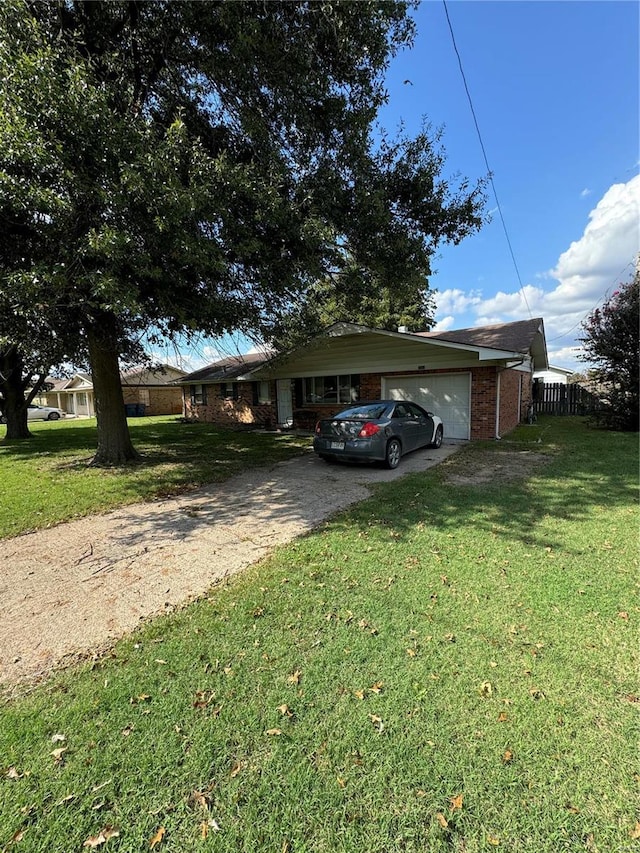 ranch-style home with a front yard and a garage