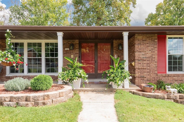 view of exterior entry with a porch