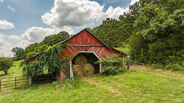 view of outbuilding with a yard