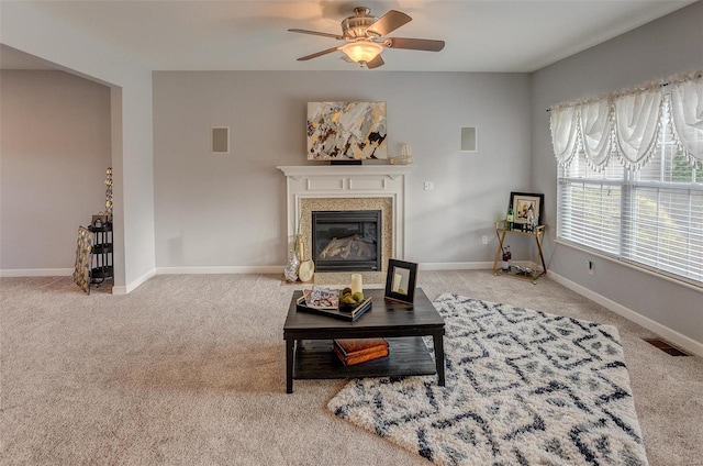 carpeted living room featuring ceiling fan