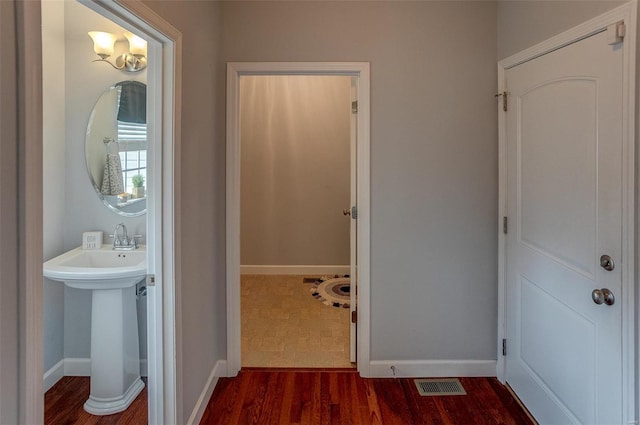 bathroom with hardwood / wood-style flooring and sink