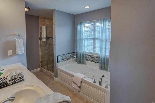 bathroom featuring shower with separate bathtub, vanity, and tile patterned floors