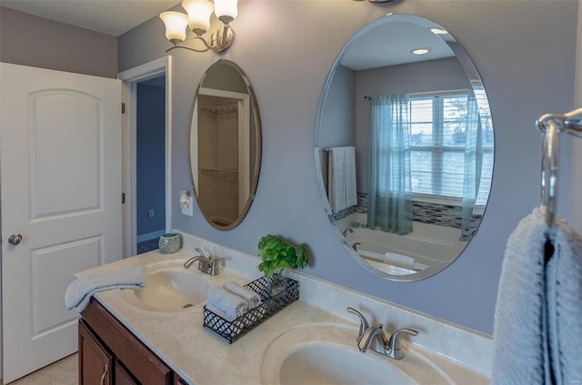 bathroom with vanity, a tub to relax in, and an inviting chandelier