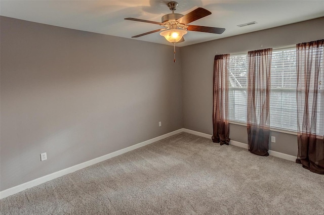 unfurnished room featuring light carpet and ceiling fan