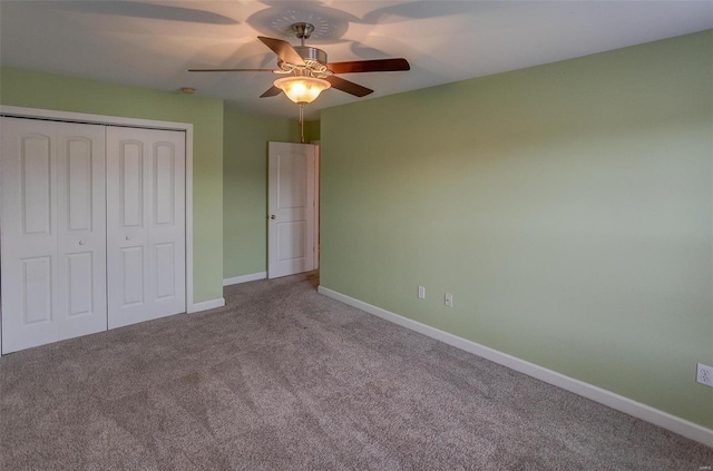 unfurnished bedroom featuring ceiling fan, light colored carpet, and a closet