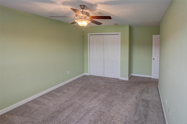 unfurnished bedroom featuring ceiling fan, light colored carpet, and a closet