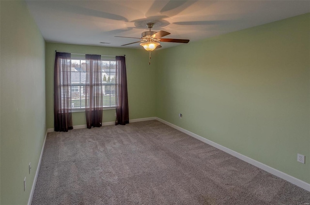 unfurnished room featuring light colored carpet and ceiling fan