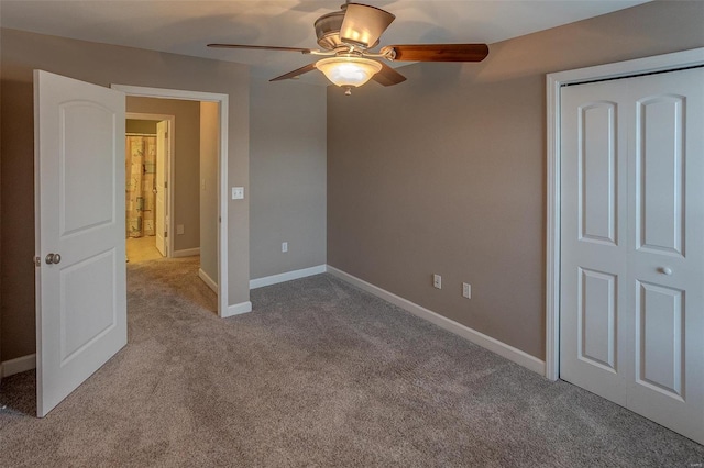 unfurnished bedroom with a closet, light colored carpet, and ceiling fan