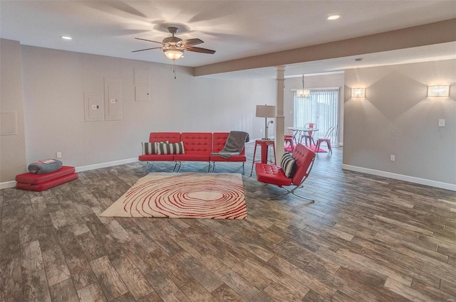 living area featuring ceiling fan and dark wood-type flooring