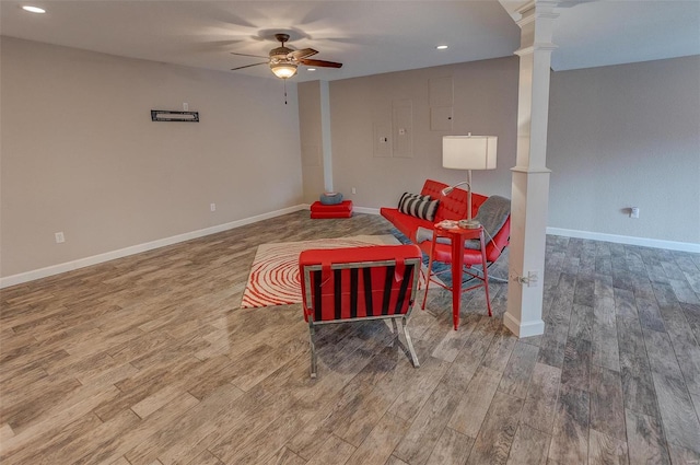 interior space featuring hardwood / wood-style flooring, ornate columns, and ceiling fan