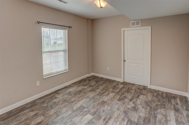 unfurnished room with hardwood / wood-style flooring