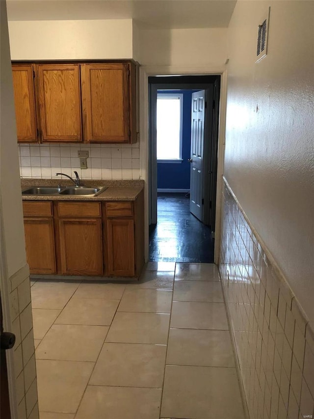 kitchen featuring sink and light tile patterned floors