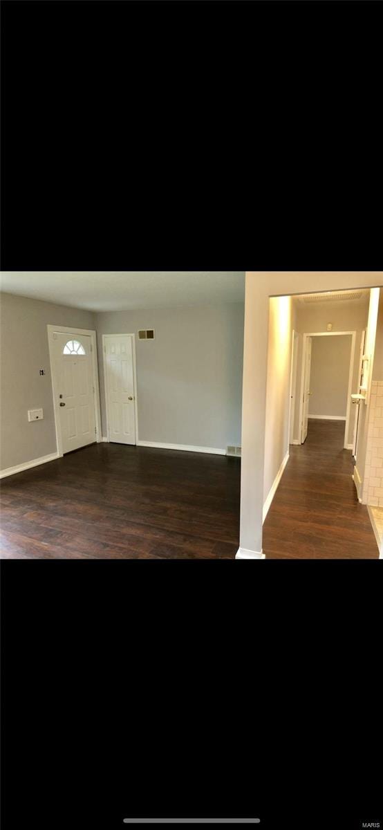 spare room featuring dark hardwood / wood-style flooring