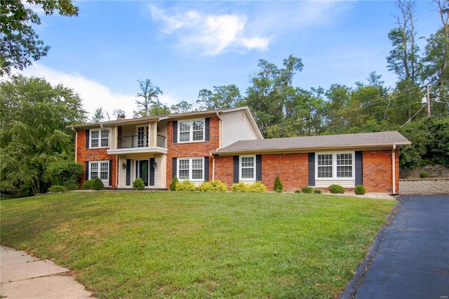 view of front of property with a balcony and a front yard