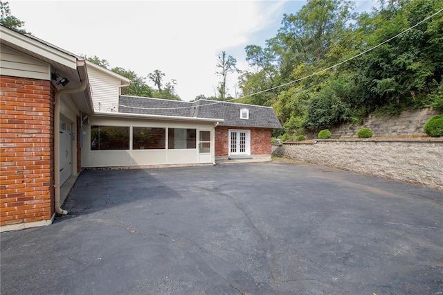 exterior space featuring a garage and french doors