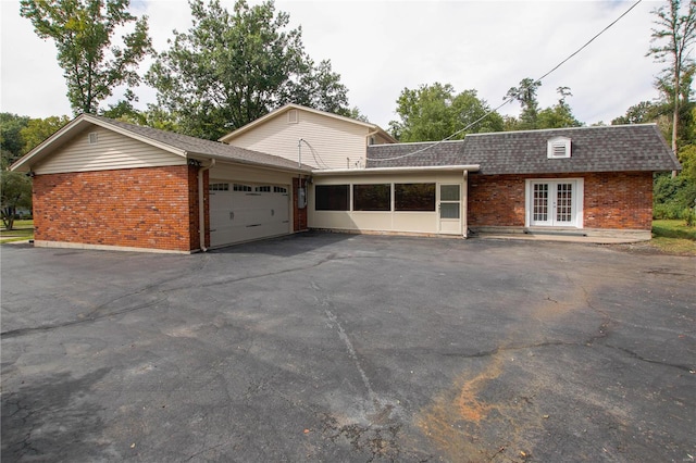 view of front of house with a garage and french doors