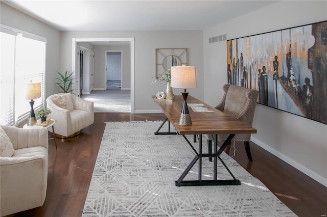 office space with dark wood-type flooring