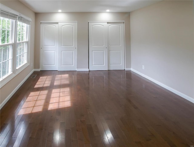 unfurnished bedroom featuring dark wood-type flooring