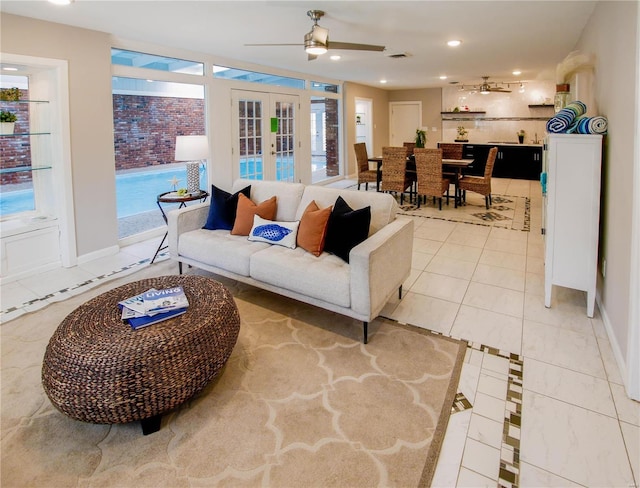 living room featuring tile patterned floors, ceiling fan, and french doors