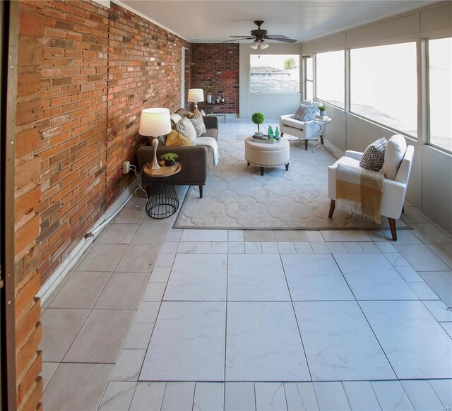 unfurnished sunroom featuring ceiling fan