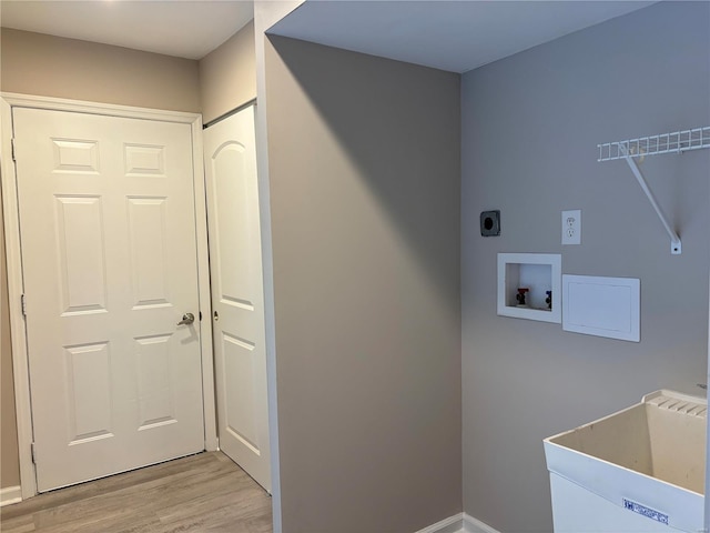 laundry area featuring hookup for a washing machine, hookup for an electric dryer, light hardwood / wood-style flooring, and sink