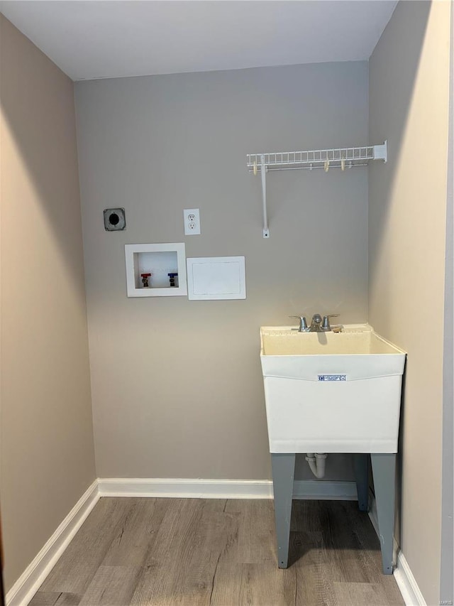 clothes washing area with hardwood / wood-style flooring, electric dryer hookup, and washer hookup