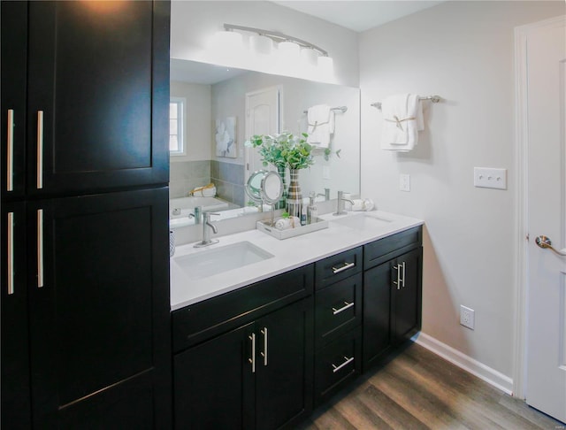 bathroom featuring a bathtub, vanity, and wood-type flooring