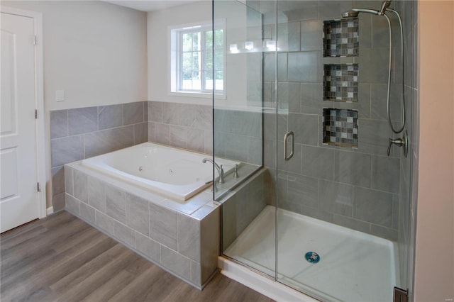 bathroom featuring separate shower and tub and wood-type flooring