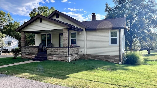 bungalow with a front lawn and a porch