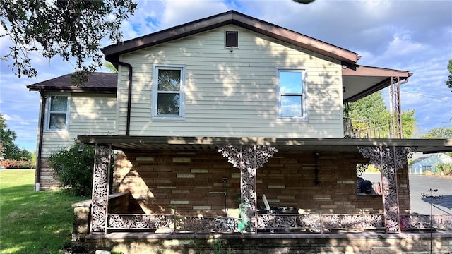 view of side of home with a yard