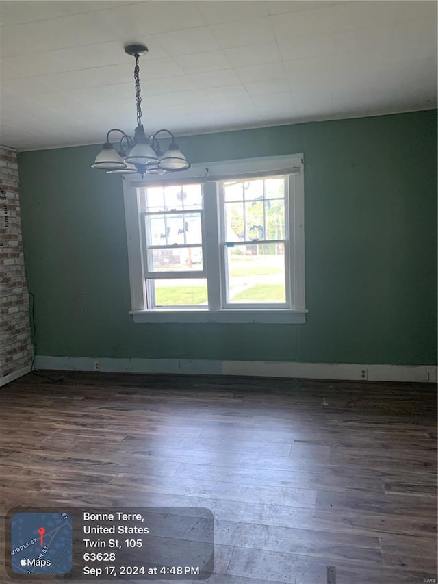 interior space featuring dark wood-type flooring and a chandelier