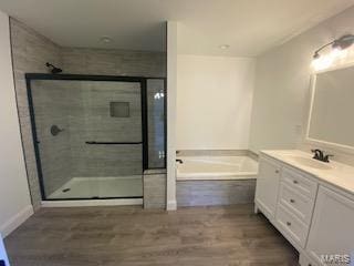 bathroom featuring vanity, shower with separate bathtub, and hardwood / wood-style flooring