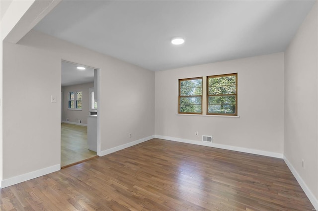 unfurnished room featuring hardwood / wood-style flooring