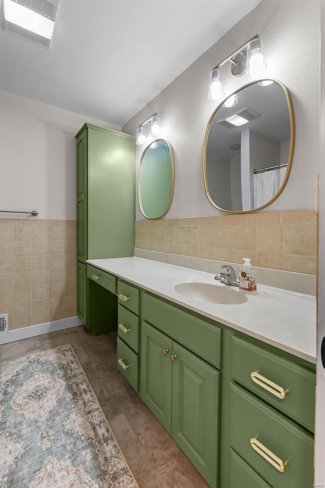 bathroom featuring vanity and tile walls