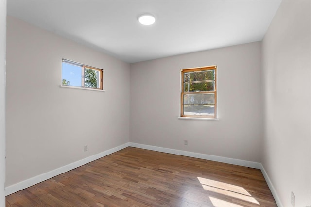 unfurnished room with wood-type flooring