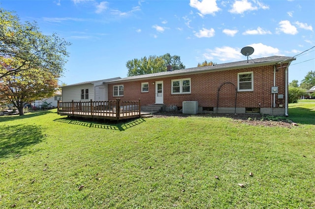 back of property with cooling unit, a yard, and a wooden deck