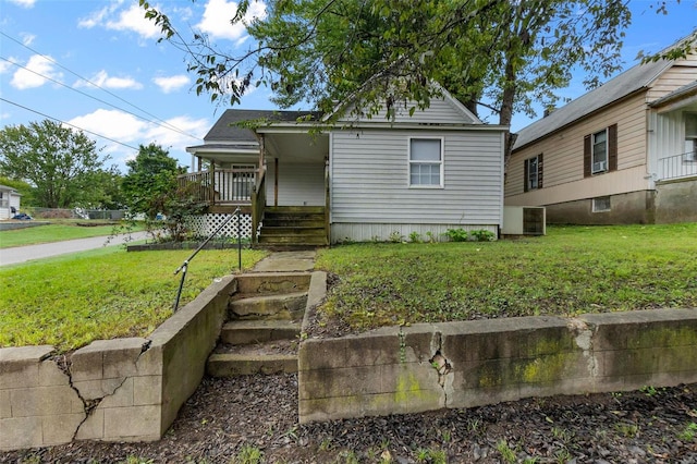 bungalow-style home with a front lawn