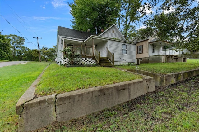 view of front of property with central air condition unit and a front yard