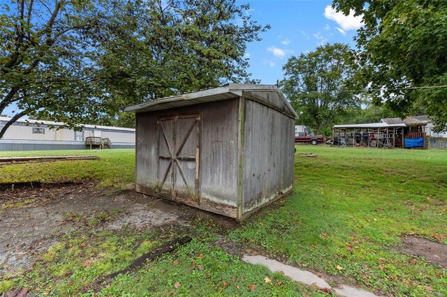 view of outdoor structure featuring a lawn