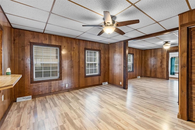 spare room featuring ceiling fan, a paneled ceiling, and light hardwood / wood-style floors