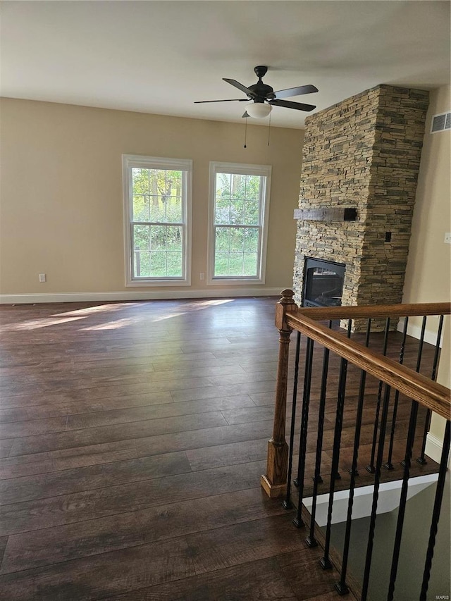 living room with ceiling fan, a fireplace, and dark hardwood / wood-style flooring