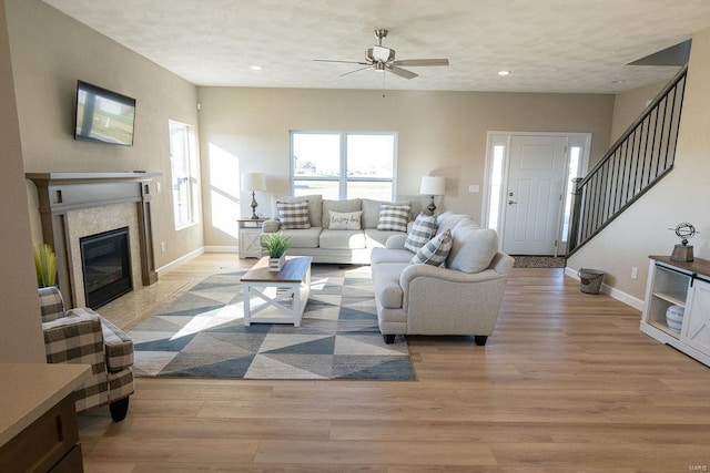 living room with ceiling fan and light hardwood / wood-style floors