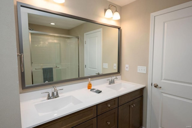 bathroom featuring vanity and a shower with shower door