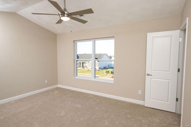 carpeted empty room with ceiling fan and lofted ceiling