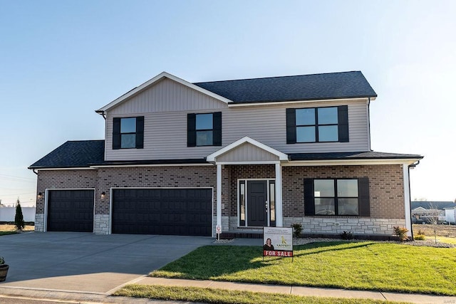 view of front facade with a garage and a front lawn