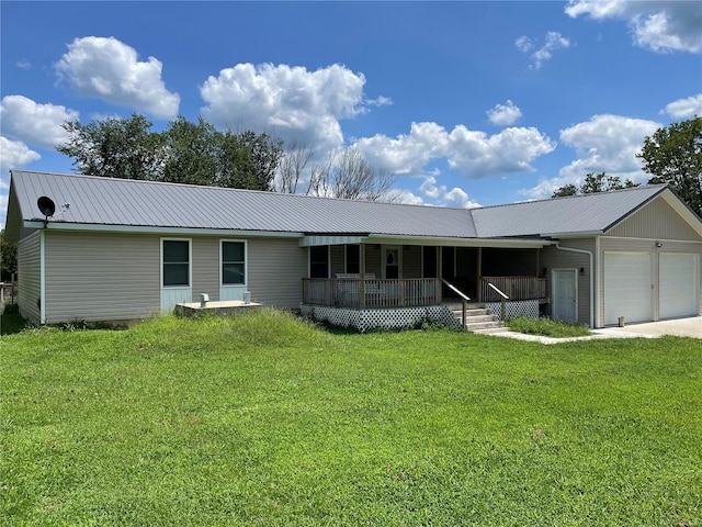 view of front of house featuring a front yard, a garage, and a porch