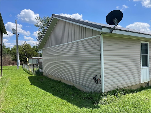 view of side of home featuring a lawn