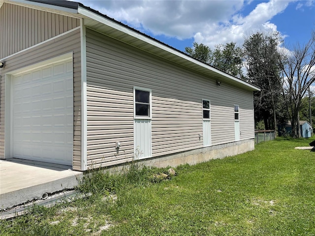 view of home's exterior featuring a yard and a garage