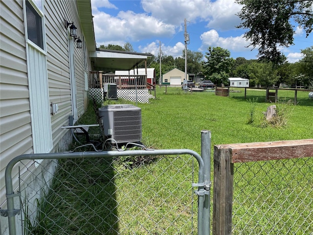 view of yard featuring cooling unit and an outdoor structure